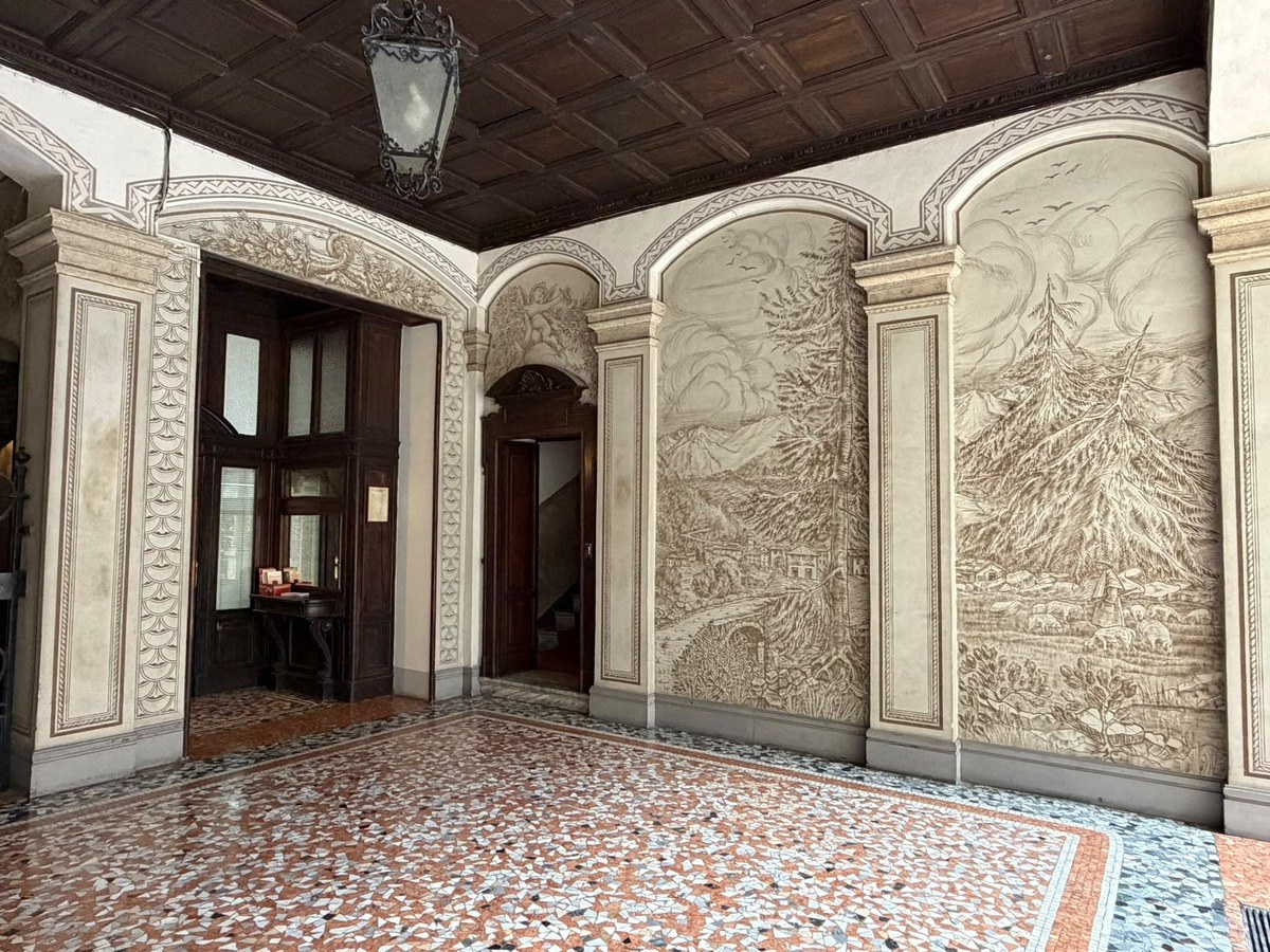 The entrance hall, with its murals and mosaic floor